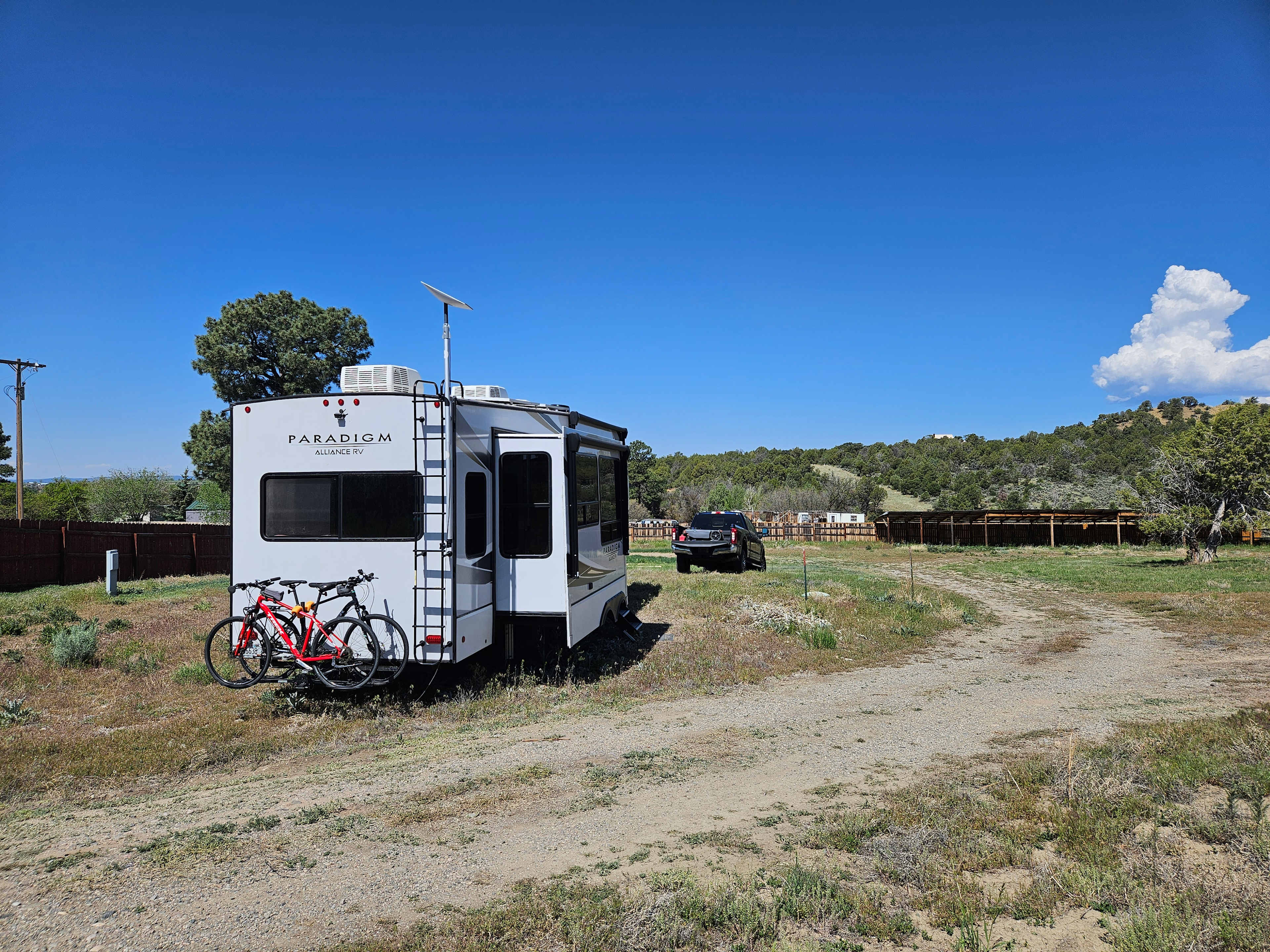 Site 2.  Rigs longer than 55-60' (when connected) might have trouble unhooking due to the slope 