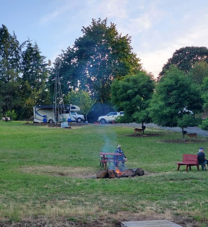 View of the community fire pit area
. RV site #1 occupied with motorhome. Deer feeding at feeders. Picture taken 7/11/2020